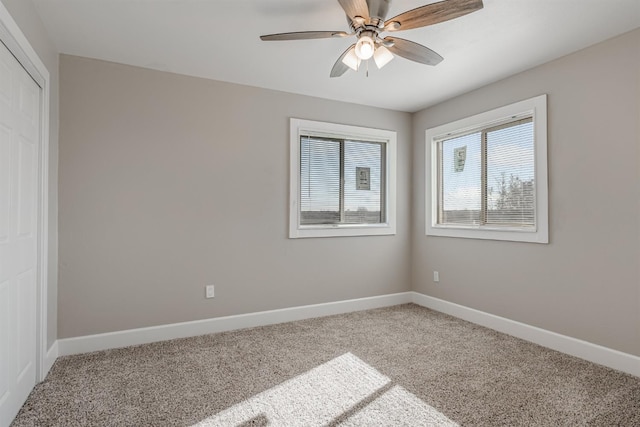 carpeted empty room featuring ceiling fan