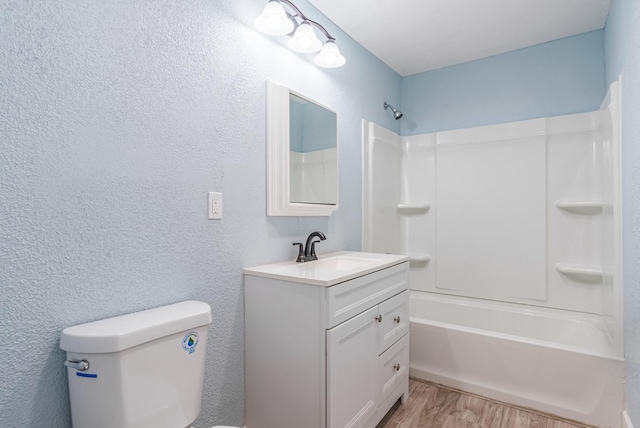 full bathroom featuring bathtub / shower combination, vanity, toilet, and hardwood / wood-style floors