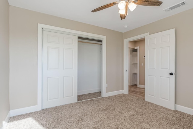 unfurnished bedroom with carpet floors, ceiling fan, and a closet