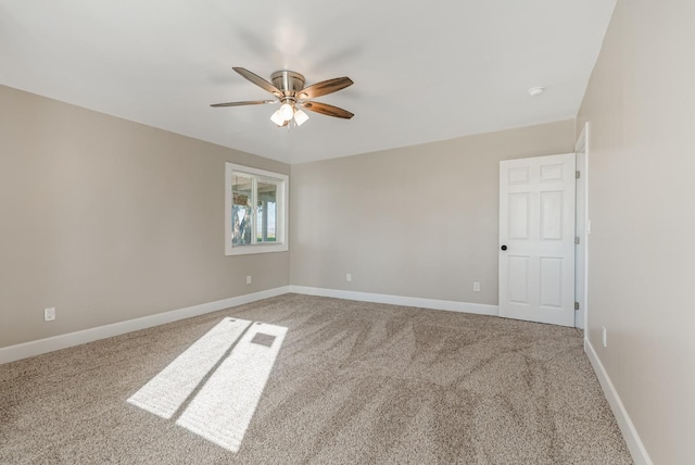 spare room featuring ceiling fan and carpet