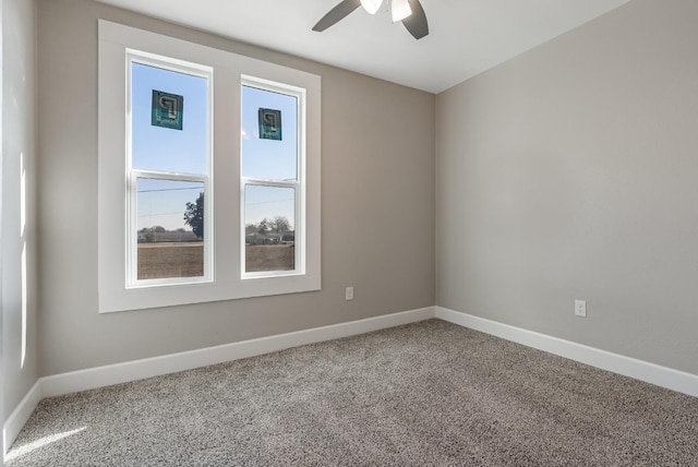 spare room featuring ceiling fan and carpet floors