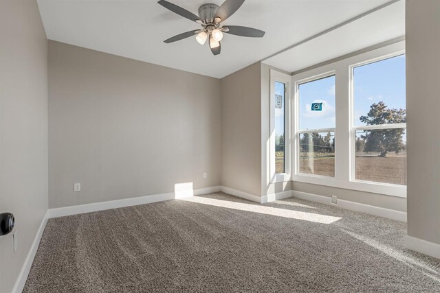 carpeted spare room with plenty of natural light and ceiling fan