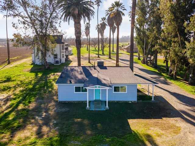 rear view of property featuring a lawn