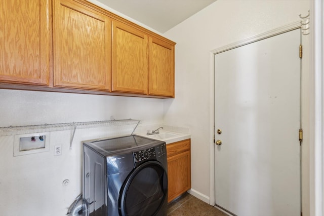 laundry room with cabinets, washer / dryer, sink, and dark tile patterned flooring