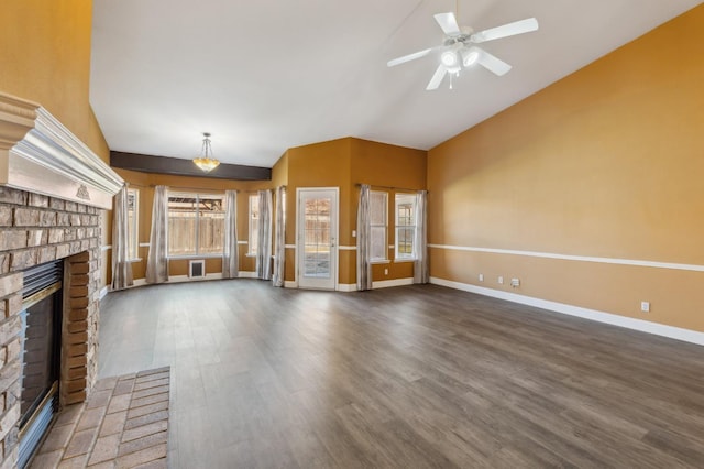 unfurnished living room with ceiling fan, dark hardwood / wood-style floors, vaulted ceiling, and a brick fireplace