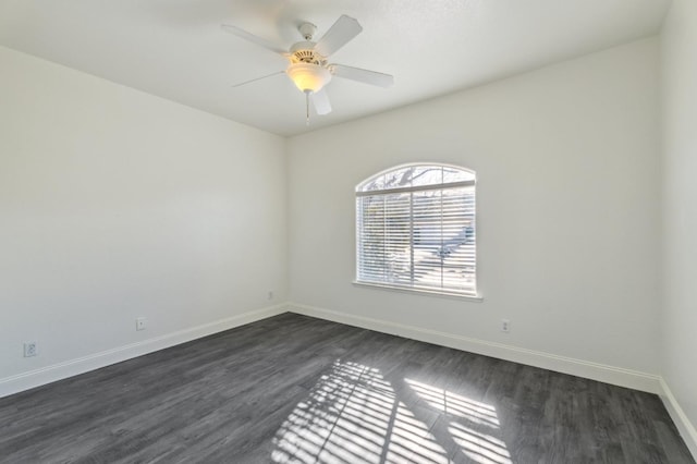 unfurnished room featuring dark wood-type flooring and ceiling fan