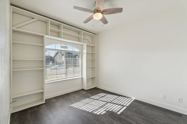 empty room with ceiling fan and dark hardwood / wood-style floors