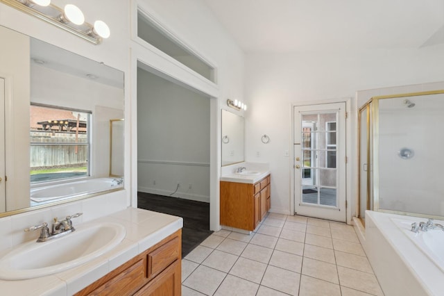 bathroom featuring independent shower and bath, vanity, and tile patterned floors