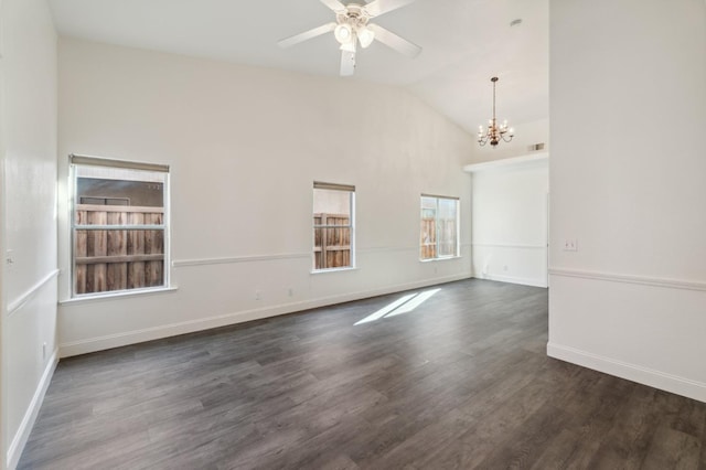 empty room featuring dark hardwood / wood-style flooring, ceiling fan with notable chandelier, and vaulted ceiling