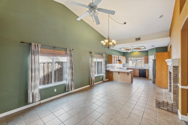 kitchen with light tile patterned flooring, ceiling fan with notable chandelier, a fireplace, dishwasher, and kitchen peninsula