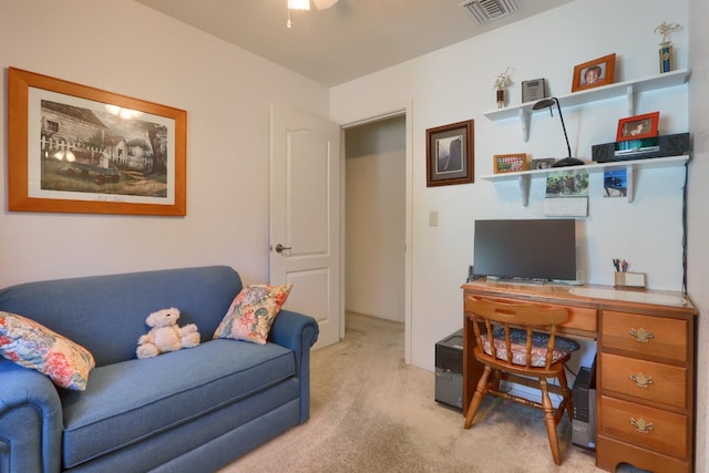 office area with visible vents, light colored carpet, and a ceiling fan