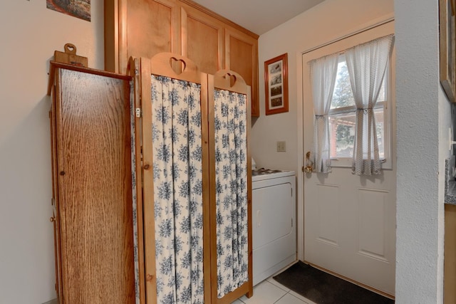 doorway with light tile patterned floors and washer / clothes dryer