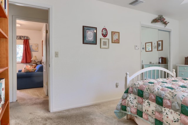 carpeted bedroom featuring visible vents and baseboards