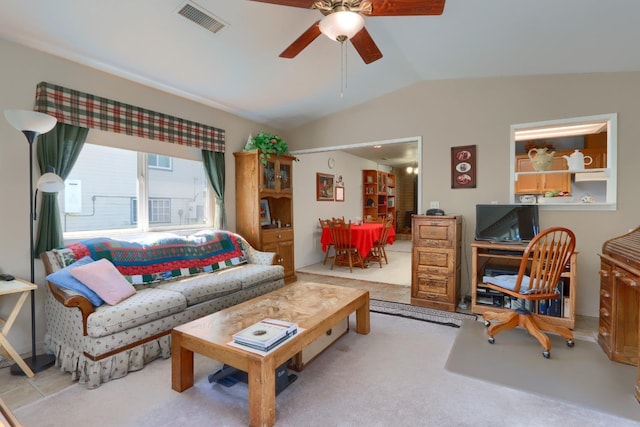 living room featuring visible vents, lofted ceiling, carpet, and a ceiling fan