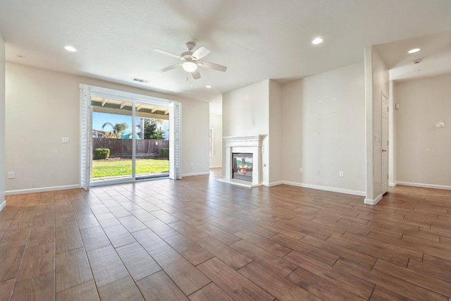 unfurnished living room with ceiling fan