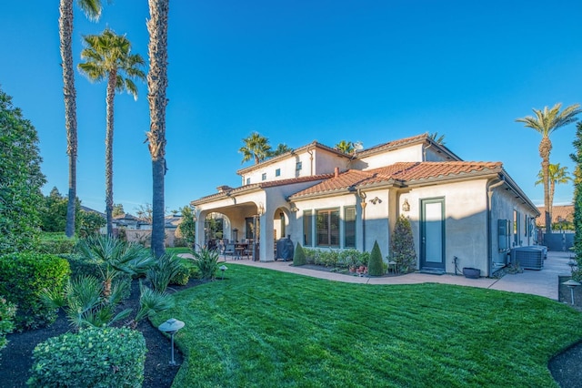 rear view of house with a yard and a patio