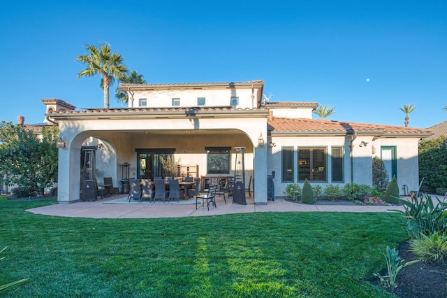 rear view of house with a patio and a yard