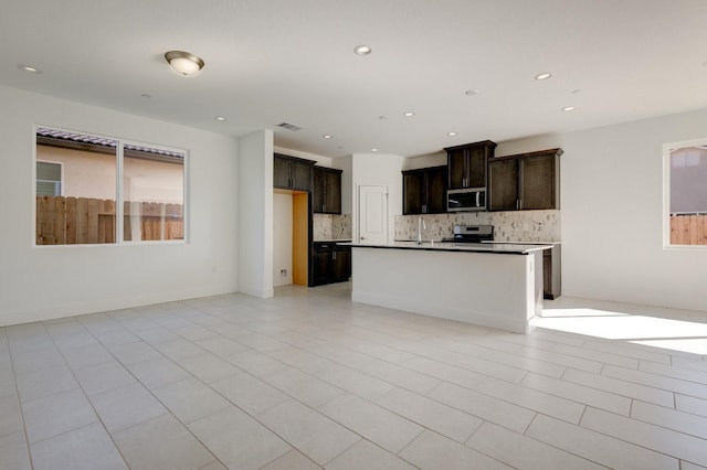 661 Lucas Ave S, Madera, CA 93636 - kitchen with tasteful backsplash, recessed lighting, stainless steel appliances, visible vents, and dark brown cabinetry