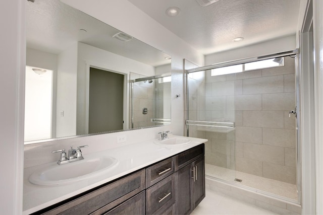 661 Lucas Ave S, Madera, CA 93636 - bathroom with a shower stall, double vanity, visible vents, and a sink