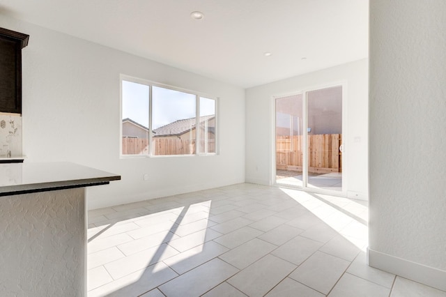 661 Lucas Ave S, Madera, CA 93636 - unfurnished living room with baseboards and light tile patterned floors