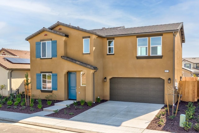 661 Lucas Ave S, Madera, CA 93636 - view of front of house featuring stucco siding, fence, a tiled roof, driveway, and a garage
