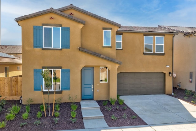 661 Lucas Ave S, Madera, CA 93636 - view of front of home with stucco siding, fence, a garage, and concrete driveway