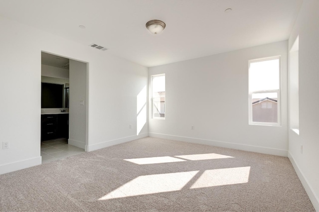 661 Lucas Ave S, Madera, CA 93636 - unfurnished bedroom featuring multiple windows, visible vents, baseboards, and carpet flooring