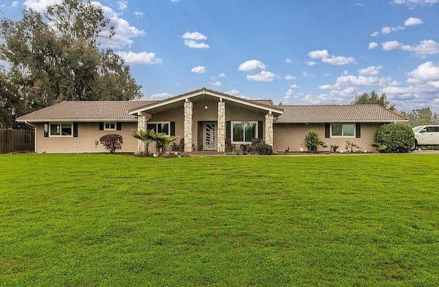 ranch-style home with a front lawn