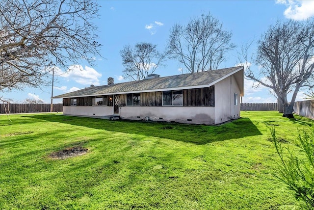 rear view of property with a sunroom and a yard