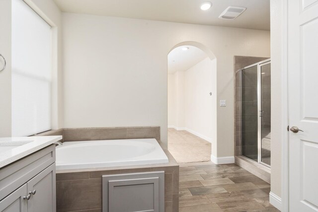 bathroom with vanity and separate shower and tub