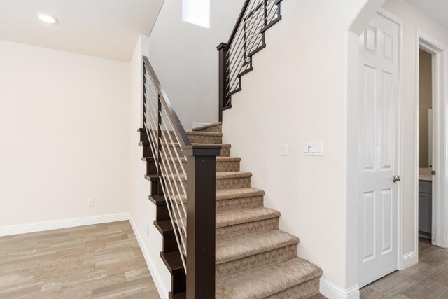 stairs with hardwood / wood-style floors