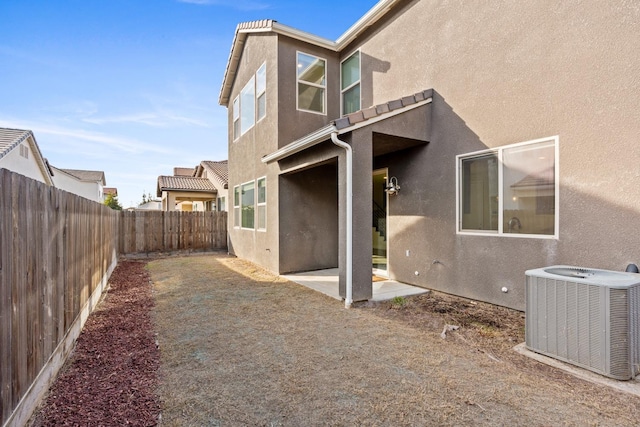 rear view of property featuring central AC and a patio