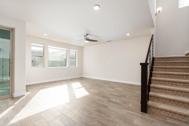 unfurnished living room with ceiling fan