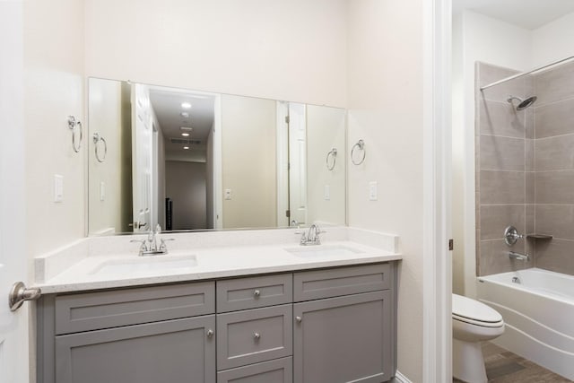 full bathroom featuring vanity, shower / bathing tub combination, hardwood / wood-style flooring, and toilet