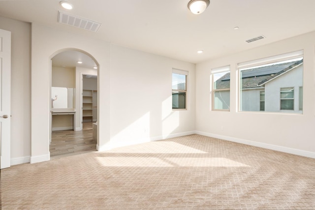 spare room with light colored carpet