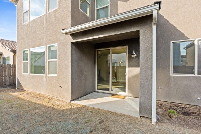 property entrance featuring a patio area