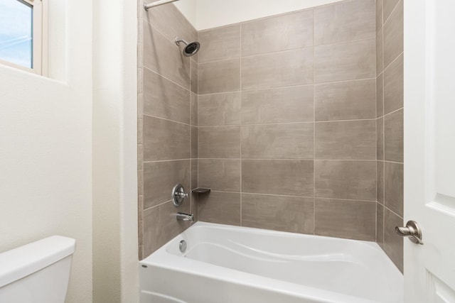 bathroom with shower / tub combination and toilet