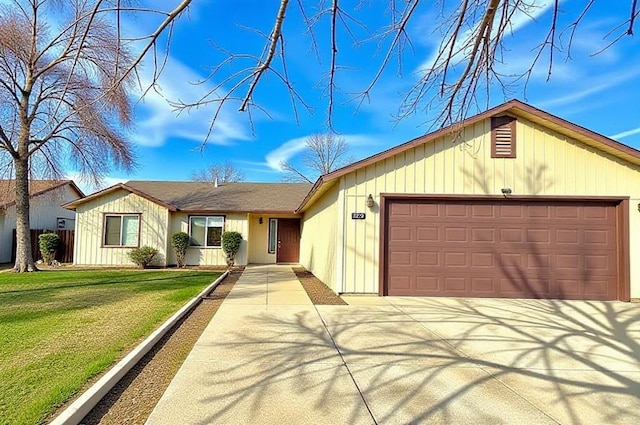 ranch-style house with an attached garage, concrete driveway, and a front yard