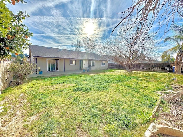 view of yard with a patio area and a fenced backyard