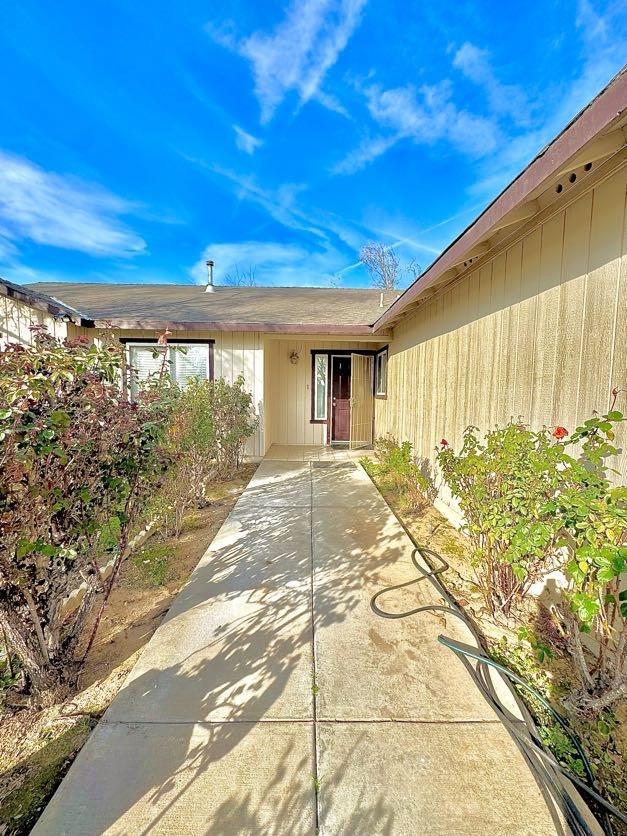 view of exterior entry featuring a patio