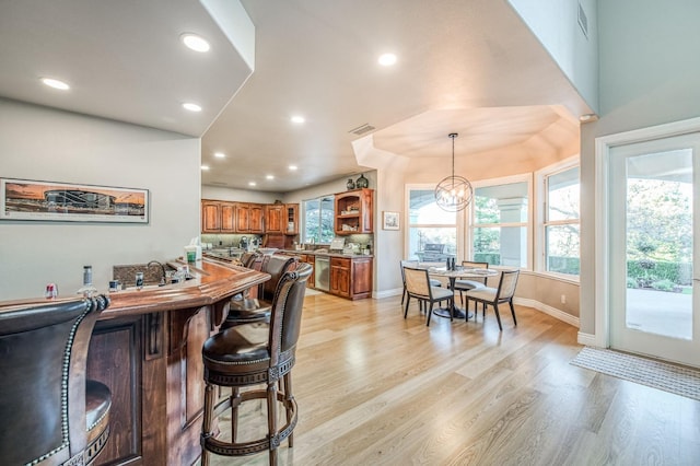 interior space featuring a notable chandelier, light hardwood / wood-style flooring, and plenty of natural light