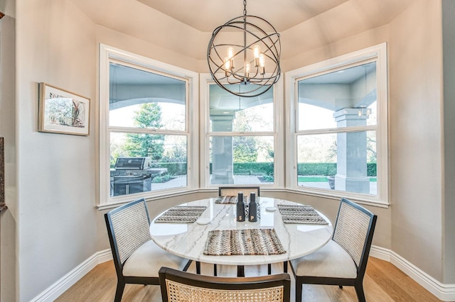 dining area featuring light hardwood / wood-style flooring and a chandelier