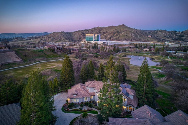 aerial view at dusk with a water and mountain view