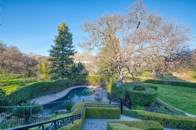 view of pool featuring a yard