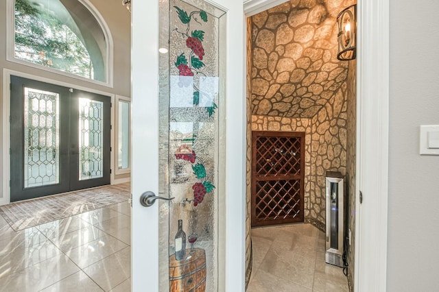 wine cellar featuring french doors and light tile patterned floors