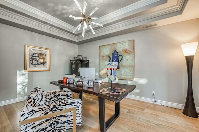 office with crown molding, a tray ceiling, and light hardwood / wood-style flooring