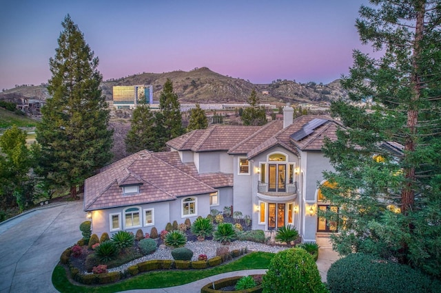 mediterranean / spanish house featuring a mountain view