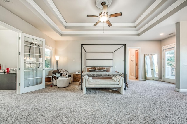 bedroom featuring carpet, access to exterior, a tray ceiling, crown molding, and french doors