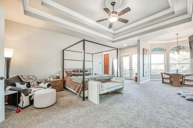 carpeted bedroom with ornamental molding, a tray ceiling, ceiling fan with notable chandelier, and access to exterior