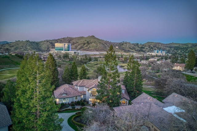 aerial view at dusk featuring a mountain view